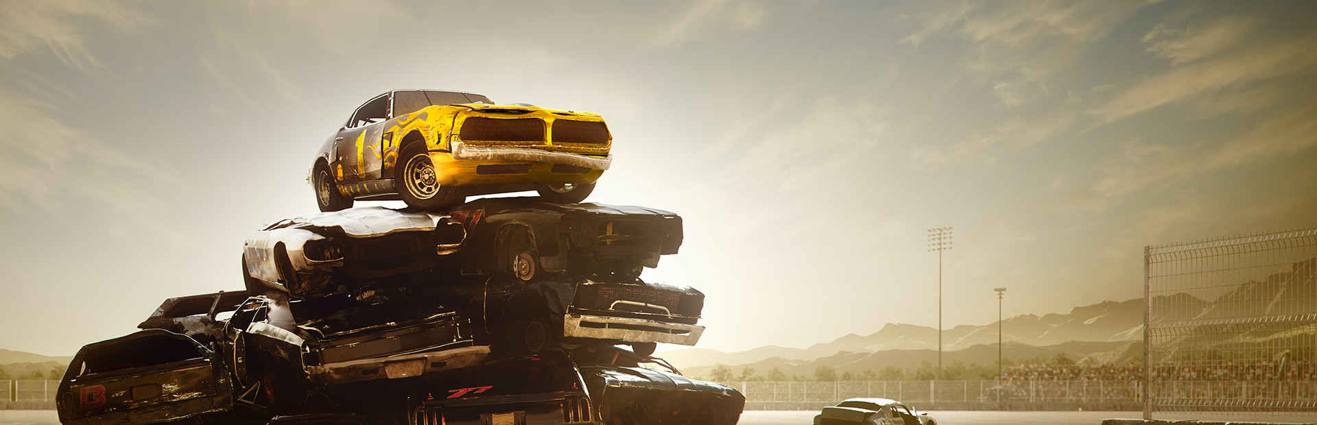 Wreckfest key art showing a yellow muscle car perched on a stack of wrecked cars at a derby track